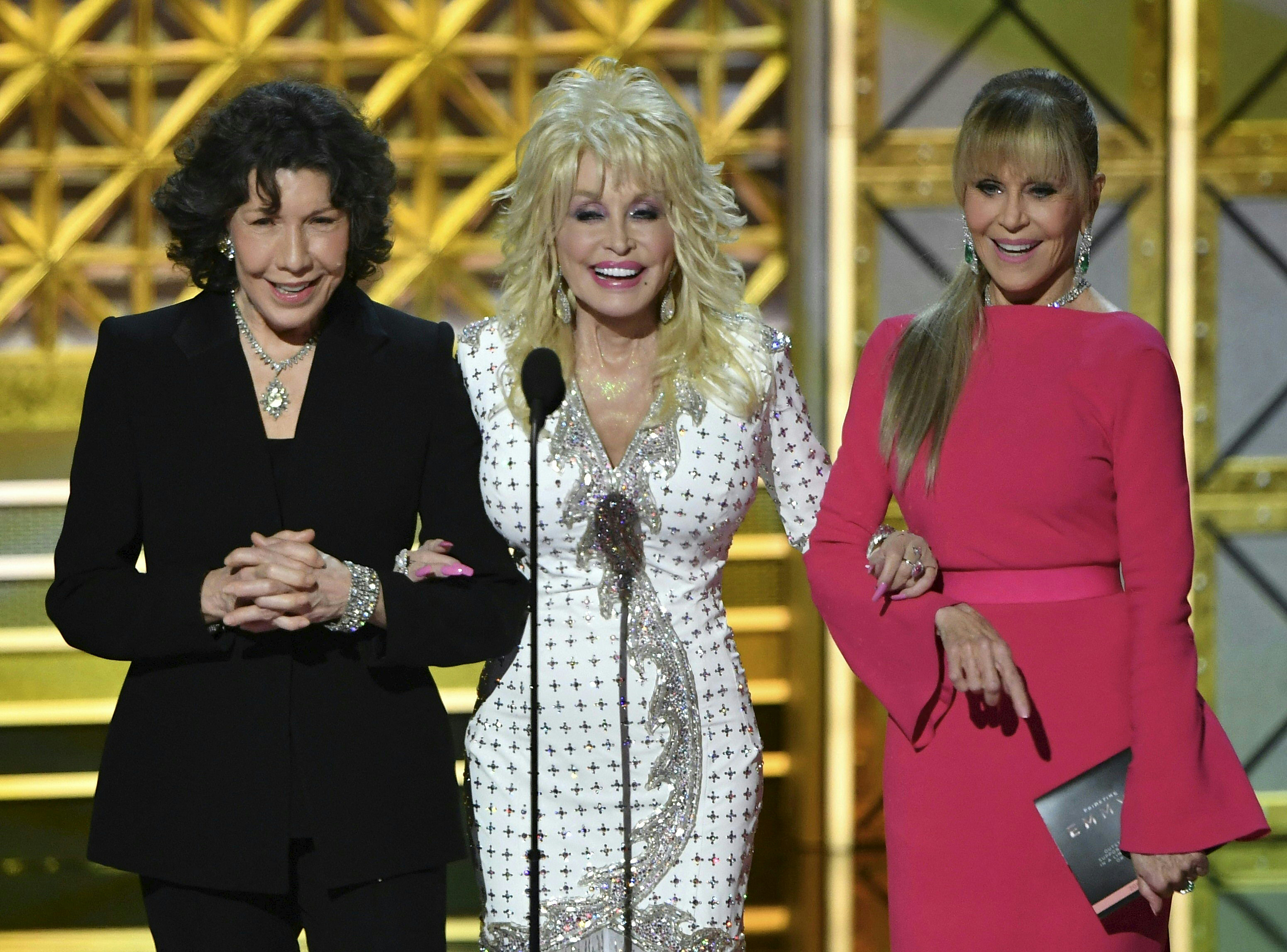 Lily Tomlin, Dolly Parton, and Jane Fonda speak during the 69th Emmy Awards on September 17, 2017 in Los Angeles, California | Source: Getty Images