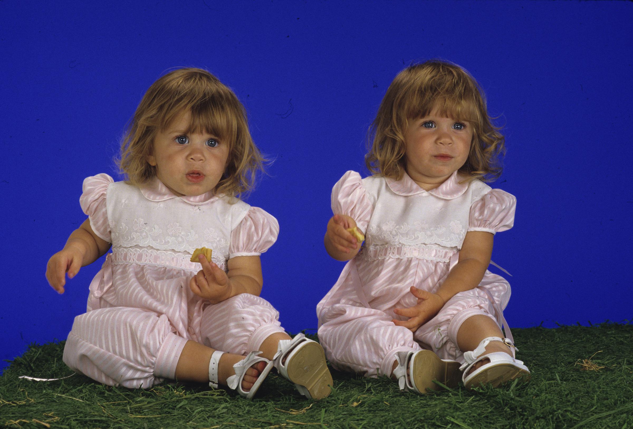 Ashley Olsen (left) and her twin sister, Mary Kate, both playing Michelle Tanner, on season 1 of "Full House" in 1988 | Source: Getty Images