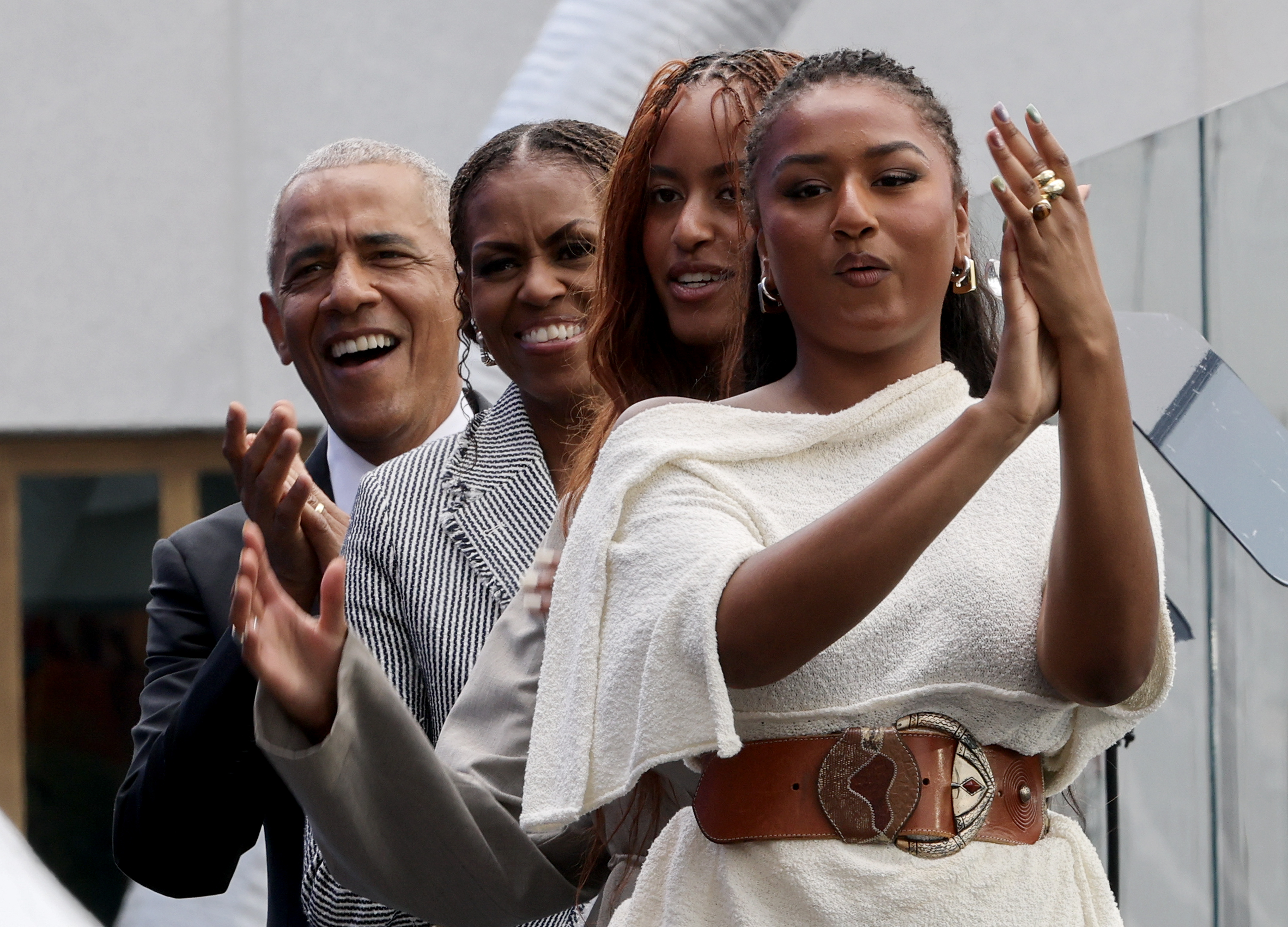 (L-R) Former U.S. President Barack Obama, Former first lady Michelle Obama, Malia Obama, and Sasha Obama cheer after the performance of Eddie Vedder and Guitars Over Guns during the dedication ceremony for the opening of the Barack Obama Presidential Center in John Lewis Plaza on June 18, 2026 in Chicago, Illinois. | Source: Getty Images