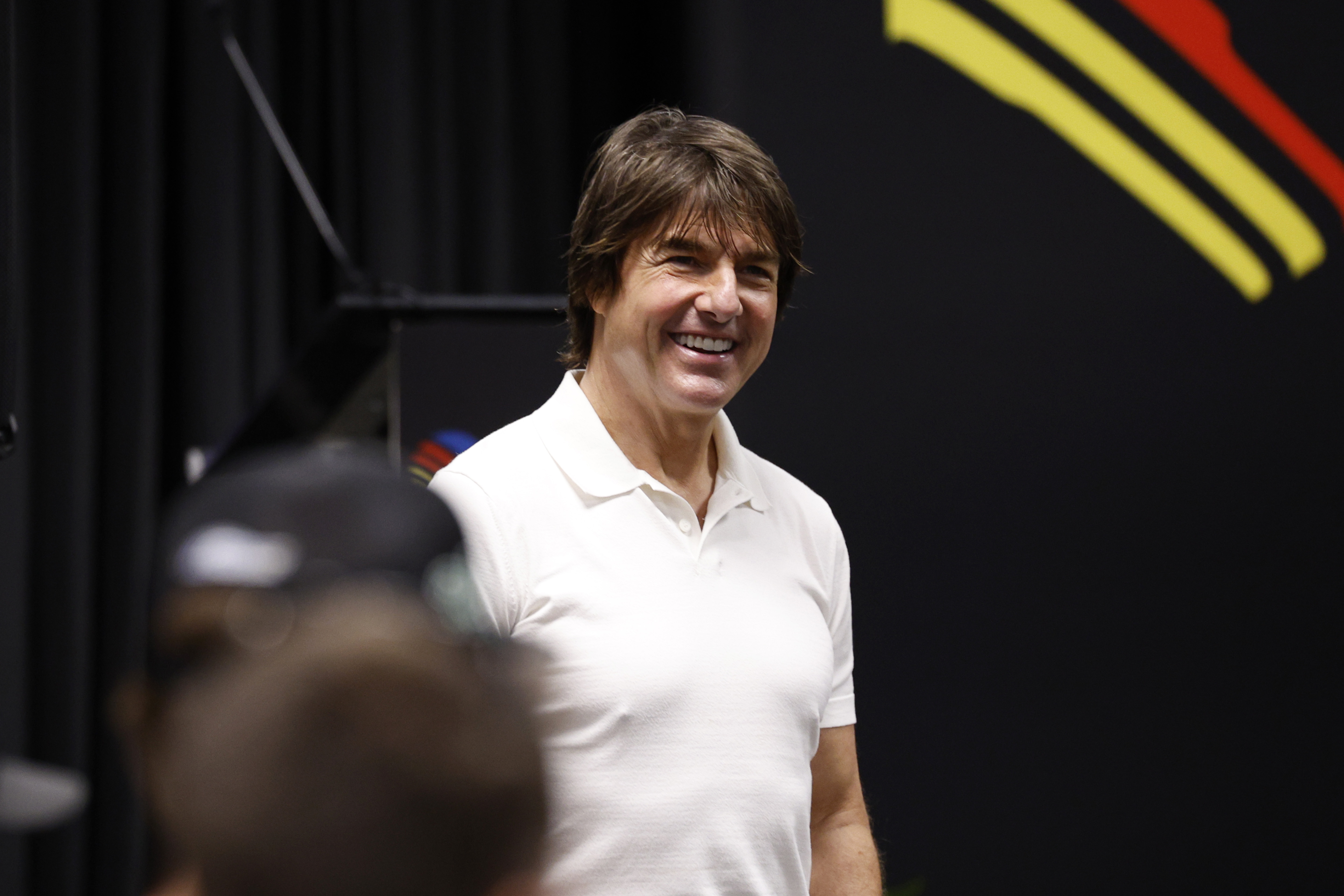 Tom Cruise speaks to guests at the NASCAR Coke Zero Sugar 400 at Daytona International Speedway on August 29, 2026 | Source: Getty Images
